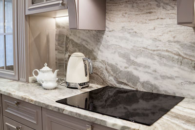 Beautiful closeup of custom designed kitchen, with marble looking quartz countertop and backsplash.