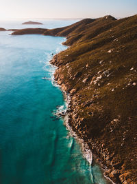 High angle view of mountains by sea