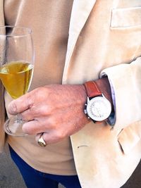 Close-up of man holding wine glass