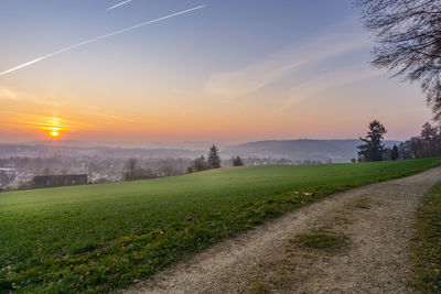 Scenic view of field against sky during sunset