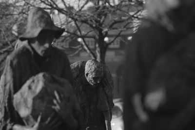 Man with lizard on tree