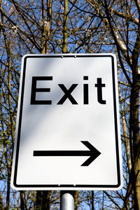 Low angle view of road sign against sky