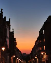 Low angle view of buildings against sky during sunset