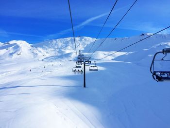 Low angle view of snow covered mountain against cloudy sky