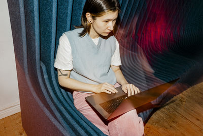 High angle view of female computer programmer using laptop at office