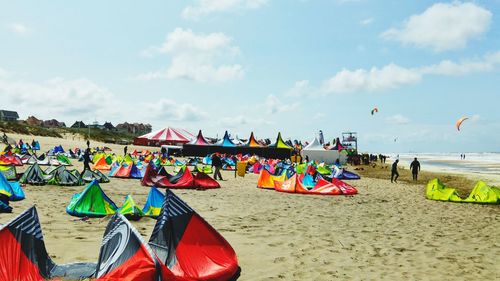 People on beach against sky