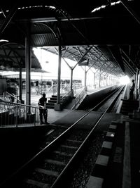 Man waiting at railroad station platform