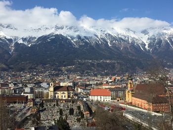 High angle view of town and mountains against sky