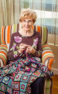 Woman sitting on sofa at home