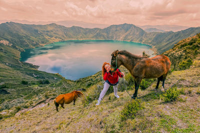 Man standing by mountains against sky