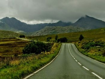 Road passing through landscape against sky