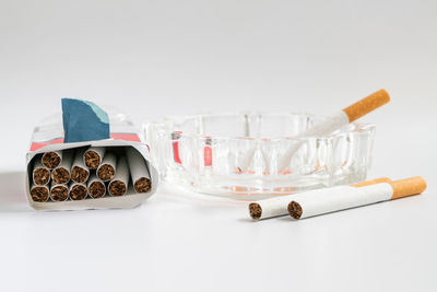 Close-up of glasses on table against white background