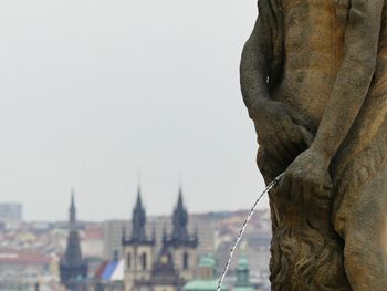 Close-up of statue in city against clear sky