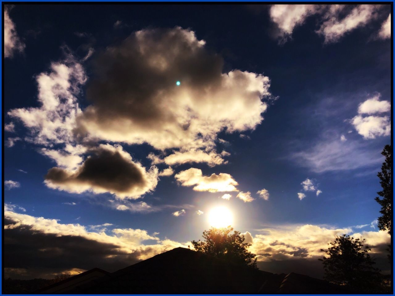 sky, cloud - sky, beauty in nature, sunset, sunlight, scenics - nature, tranquility, sun, sunbeam, silhouette, no people, tree, nature, tranquil scene, plant, low angle view, lens flare, outdoors, auto post production filter, architecture, brightly lit