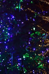 Low angle view of illuminated christmas tree at night