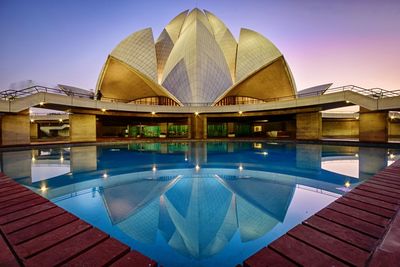 View of swimming pool in city against clear sky