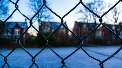 Close-up of chainlink fence against sky