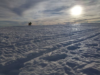 Scenic view of frozen lake against sky during sunset