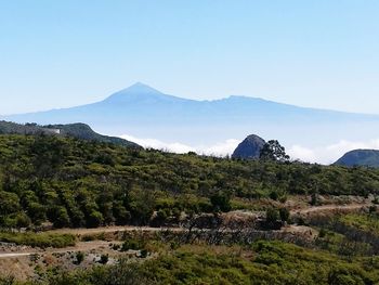 Scenic view of mountains against clear blue sky