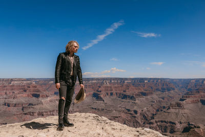 Man standing on landscape against sky