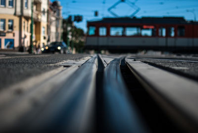 Cable car moving on tramway by buildings in city