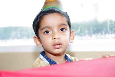 Close-up of cute boy wearing party hat