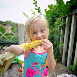 Portrait of cute girl eating food