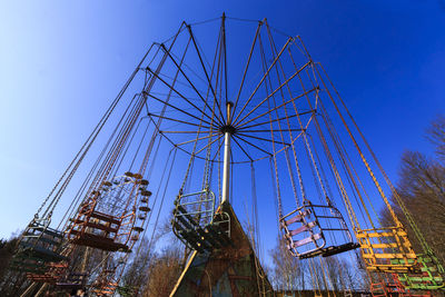 Low angle view of ferris wheel against blue sky