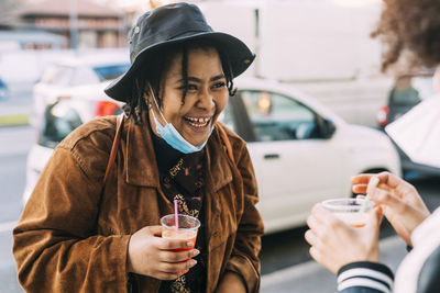 Portrait of smiling woman holding drink