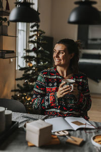 Smiling woman sitting at table