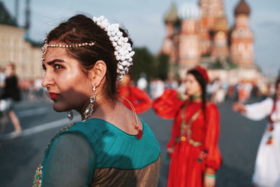 Portrait of young woman looking away outdoors