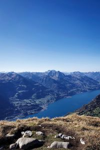 Scenic view of mountains against clear blue sky