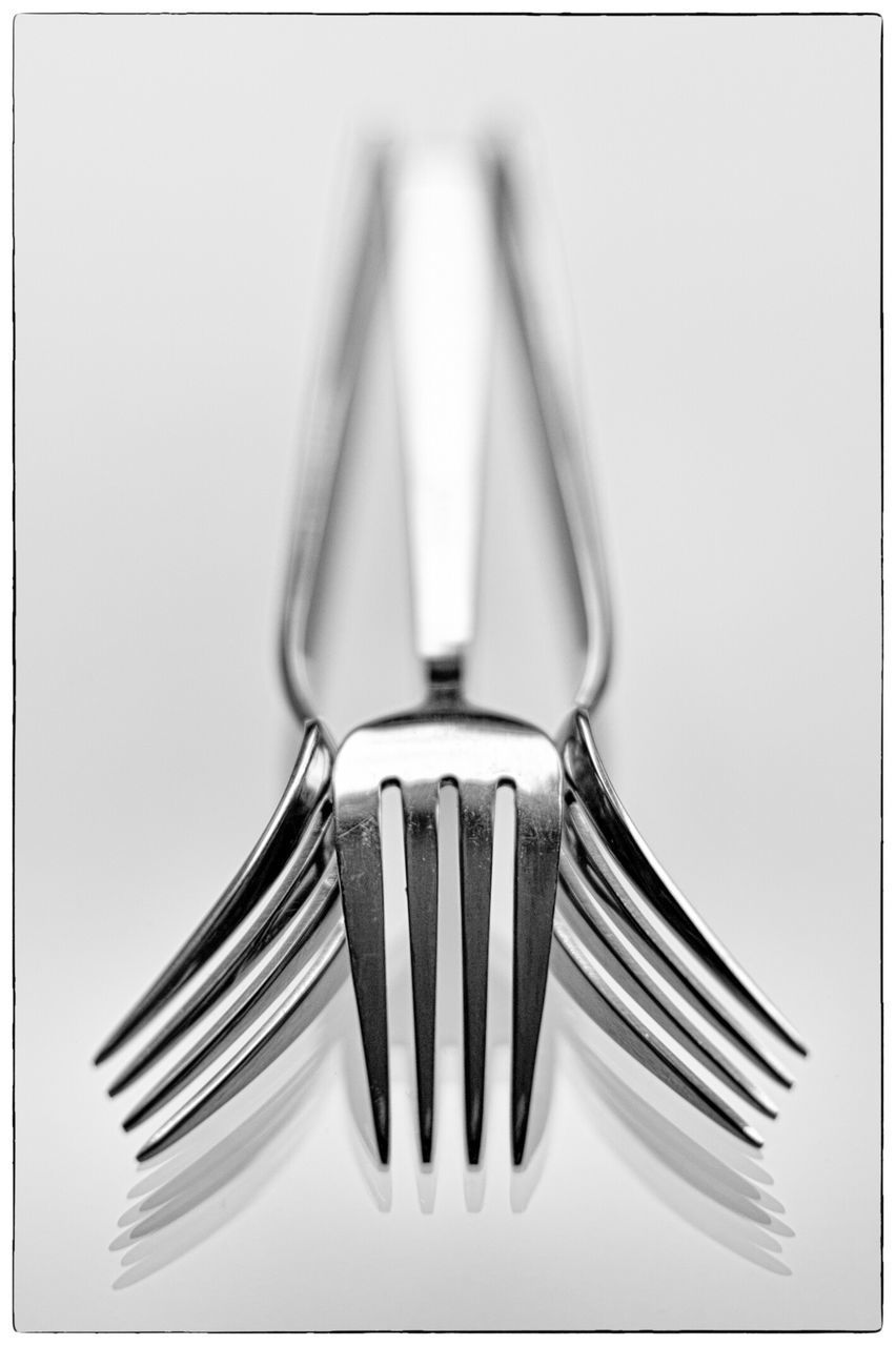 CLOSE-UP OF SPOON OVER WHITE BACKGROUND