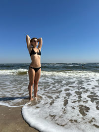 Full length of woman standing at beach