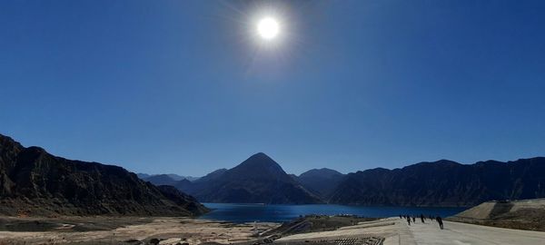 Scenic view of mountains against clear blue sky