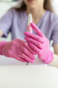 Midsection of woman holding dental equipment