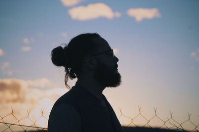 Portrait of silhouette woman standing against sky during sunset