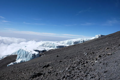 Scenic view of landscape against blue sky