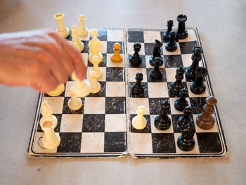 High angle view of person playing chess on table