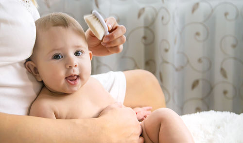 Close-up of cute baby girl at home