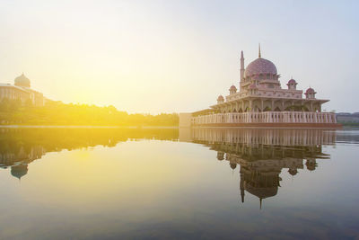 Reflection of putrajaya mosque in lake at sunset