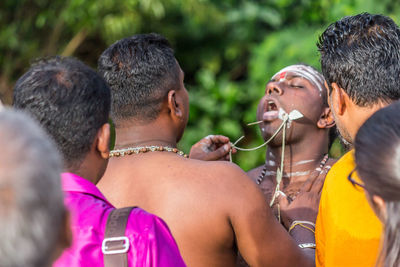 Rear view of people enjoying in traditional clothing