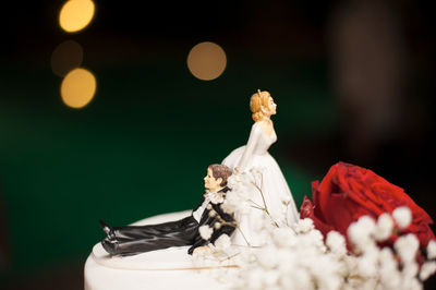 Close-up of figurines on wedding cake