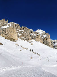 Scenic view of snowcapped mountains against clear blue sky