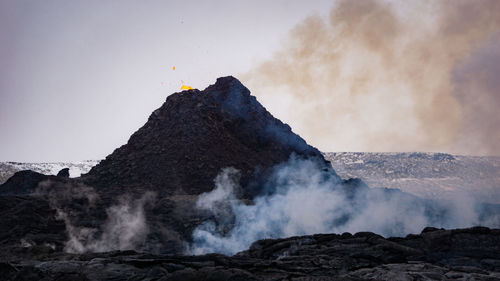 Scenic view of volcanic mountain against sky