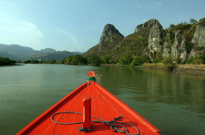 Scenic view of river with mountain range in background