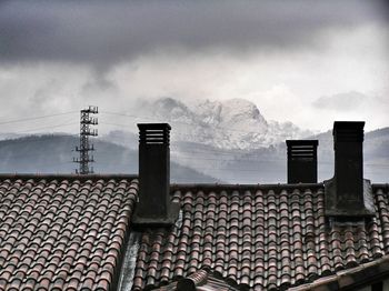 Roof of building against cloudy sky