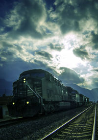 Railroad track against cloudy sky