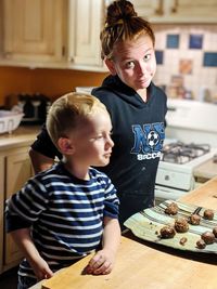 Cute boy with meat at home