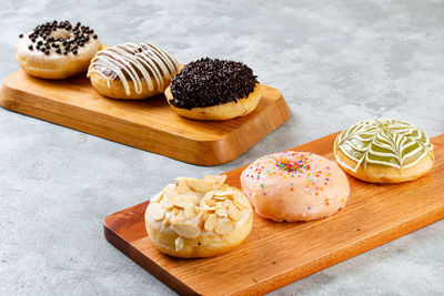 Variety of cupcakes on cutting board